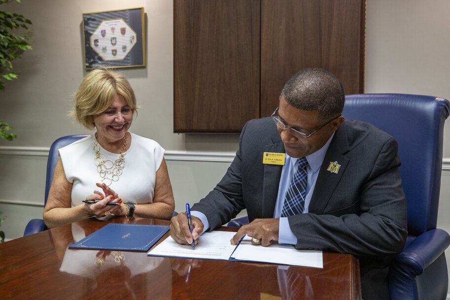 Dr. Ron K. Patterson signing partnership with We Lead CS
